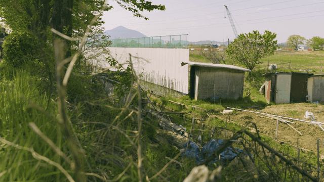 White temporary fences and temporary warehouses in field