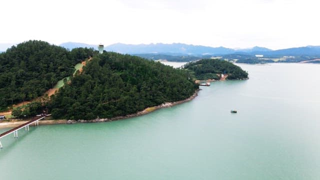 View of lush green island surrounded by calm sea