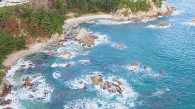 Rocky coastline with clear blue waves