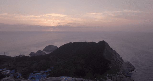 해안 산과 바다 위의 일몰