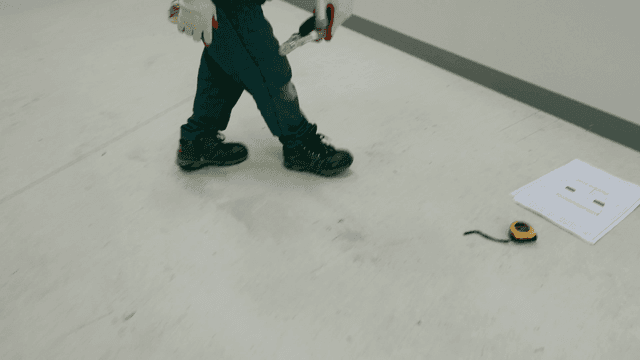 Worker carrying interior construction sign.
