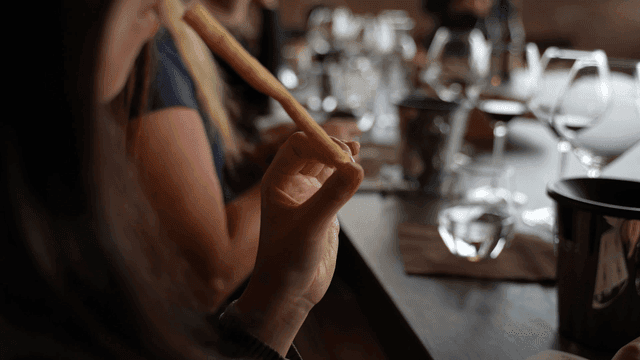 People enjoying a meal with wine
