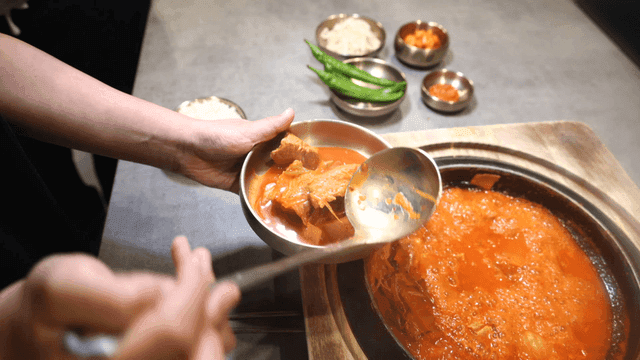 Serving kimchi stew into bowl