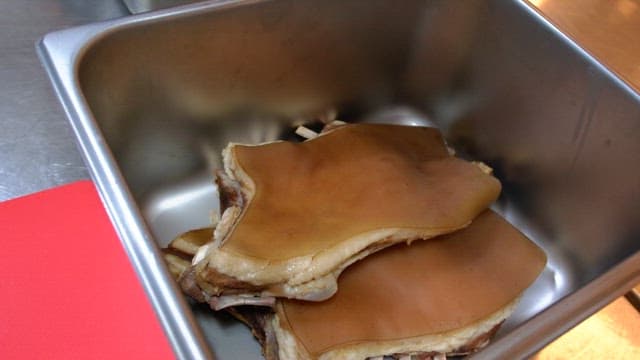 Boiled meat in a metal container in the kitchen