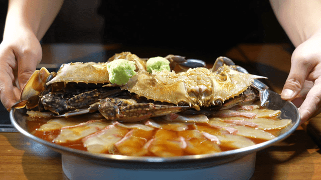 Plate of soy sauce marinated crab and raw fish