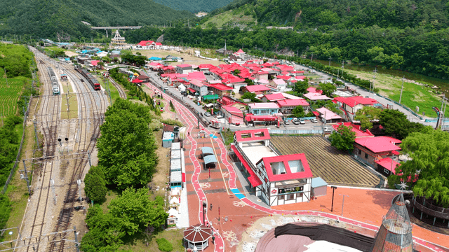 Lively rural village with red roofs and railway
