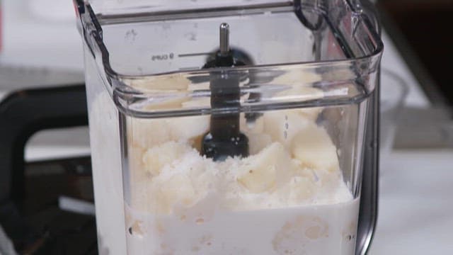 Pouring Milk into the Blender with Potatos