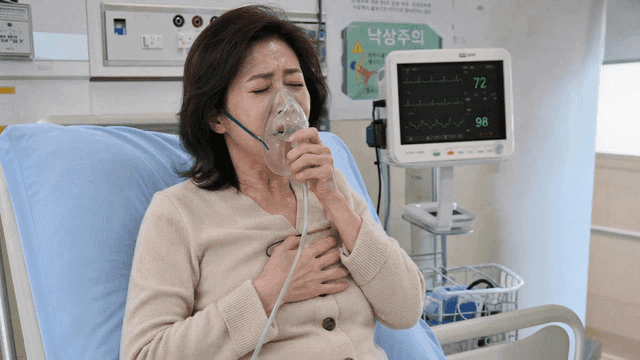 Female hospital patient using oxygen mask