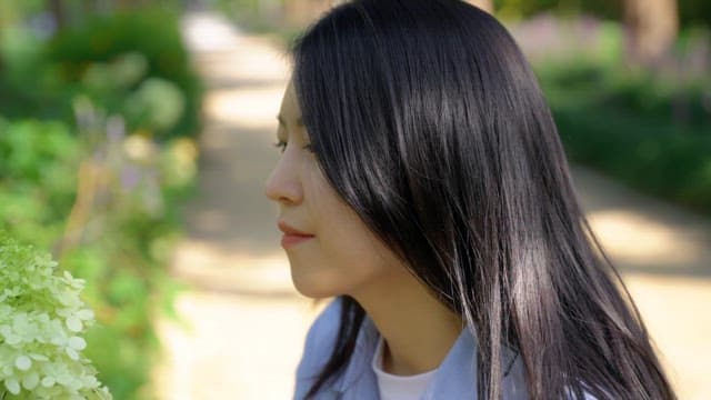 Woman enjoying flowers in a park