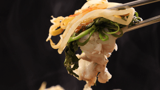 Boiled anglerfish picked up with chopsticks