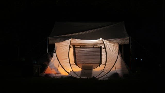 Softly lit tent in the dark at night