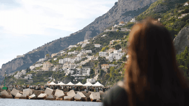 Back view of woman looking at coastal cityscape