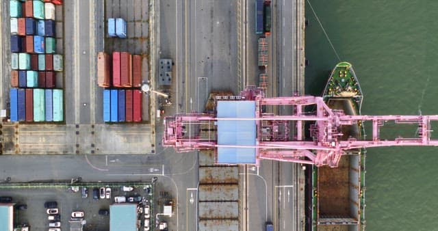 Cargo ship docked at a busy port