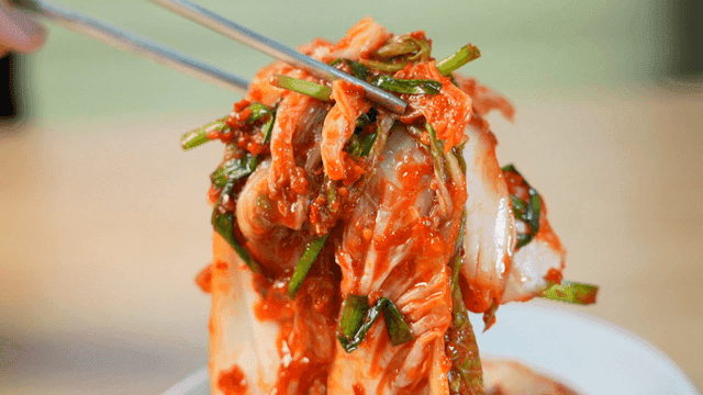 Fresh kimchi picked with chopsticks