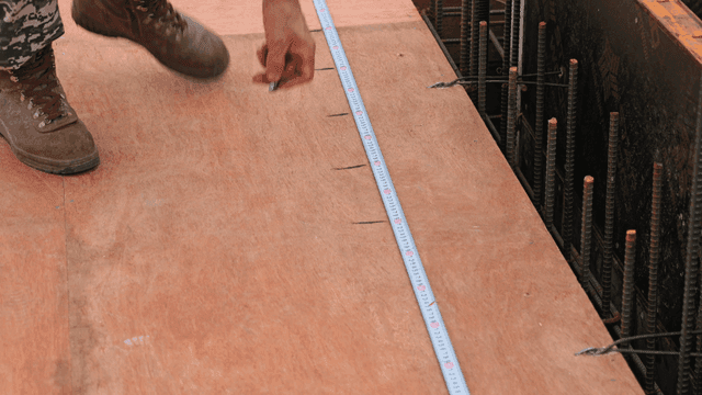 Worker measuring on a construction site
