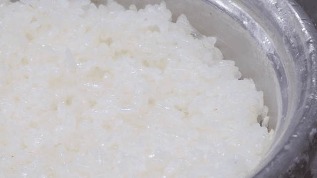 Steamed white rice in a metal pot