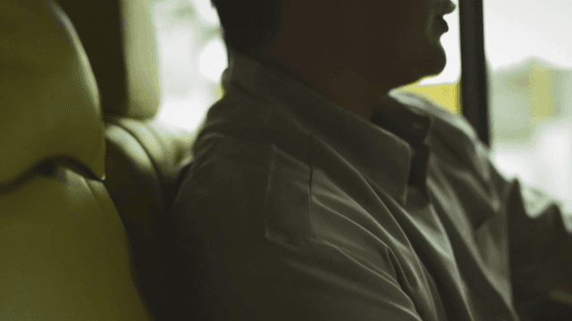 Man looking out window of moving car