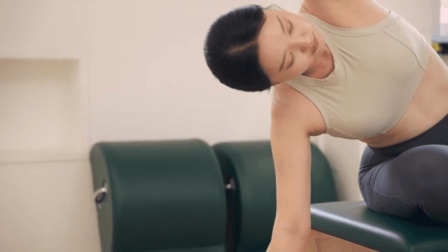 Woman practicing pilates indoors