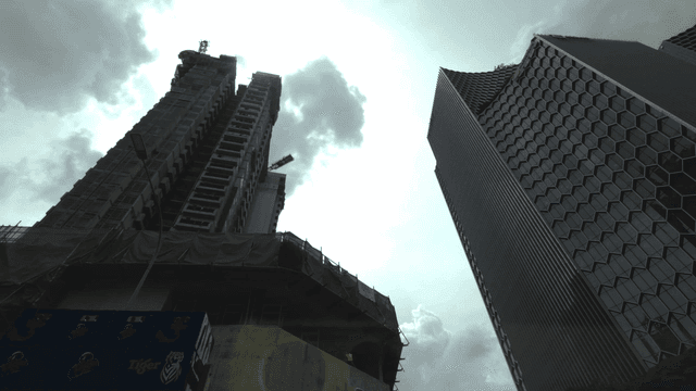 Skyscrapers under construction with clouds