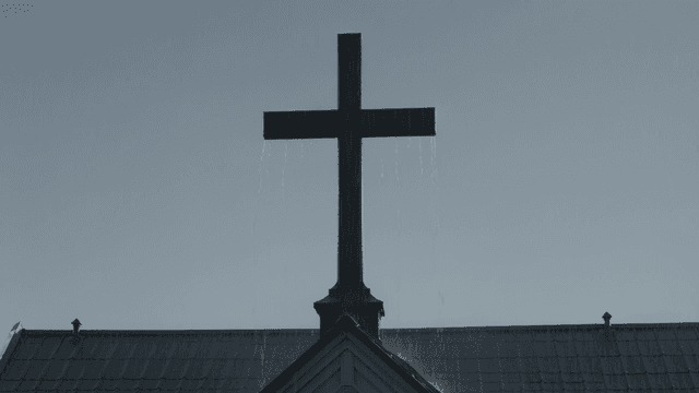 Cross under rainy sky
