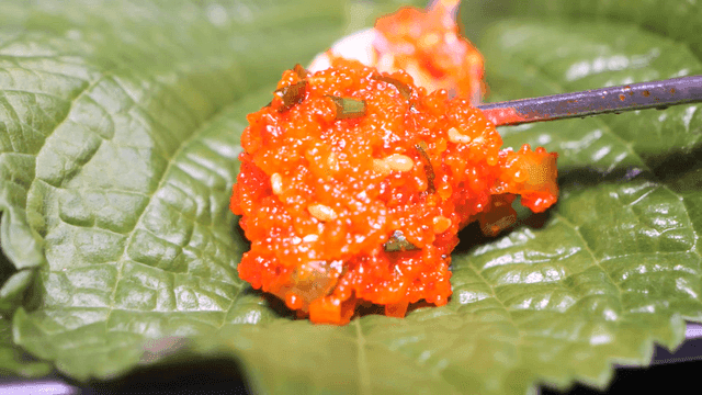 Raw fish salad served on perilla leaves