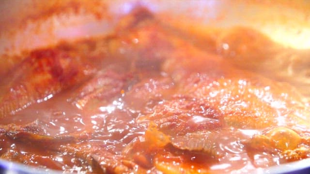 Steamed fish containing various fish simmering in a pot