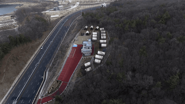 Aerial view of a campsite near a forest