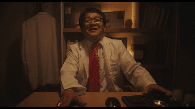 Doctor laughing while pushing away patient’s hand in clinic