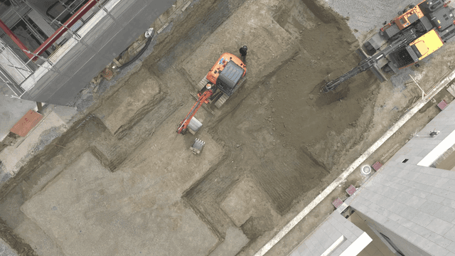 Construction site with excavator and workers