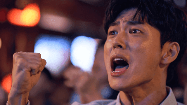 Man cheering with his fist clenched