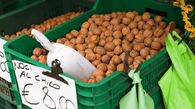 Walnuts displayed in a green crate