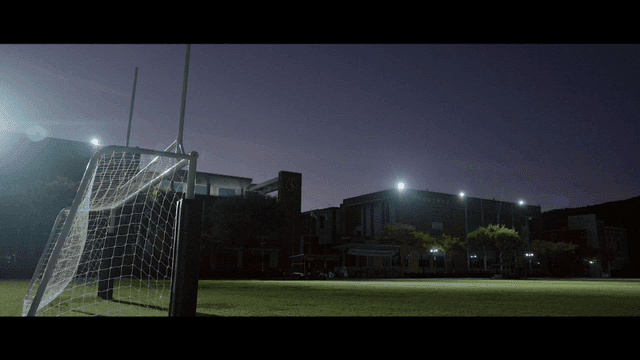 A school campus at dusk with a soccer goal