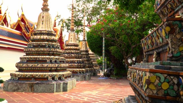 Elaborate and ornate religious architecture of Thai temples with green trees