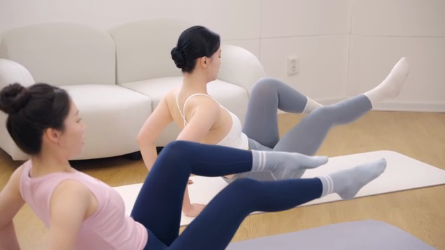Two women practicing yoga indoors