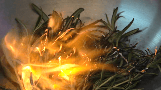 Burning rosemary on metal pan