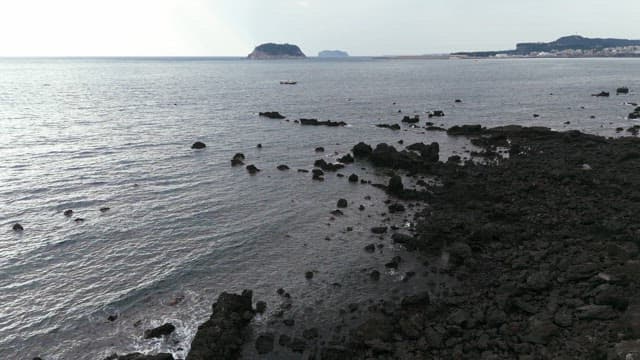 Rocky coastline with distant islands