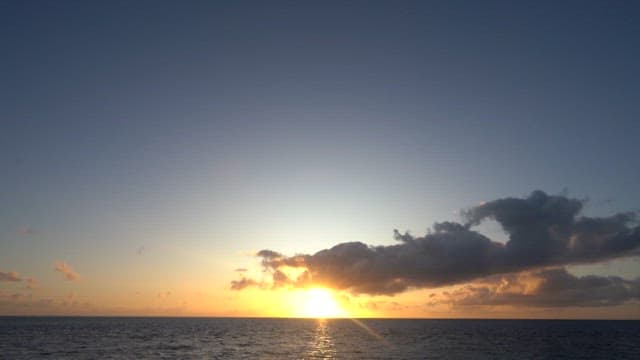 Tranquil Ocean Sunset with Clouds