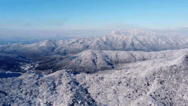Snow-covered mountains under a clear sky