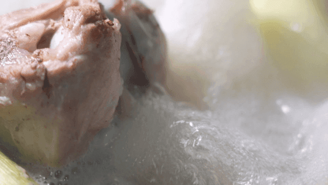 Boiling broth with chicken pieces