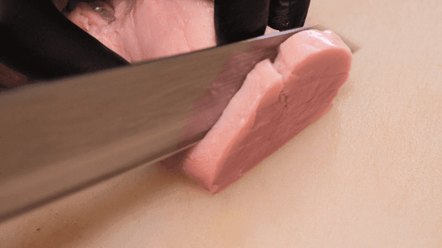 Cutting tenderloin on cutting board