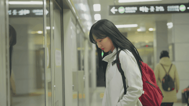 Tired young woman waiting at subway station