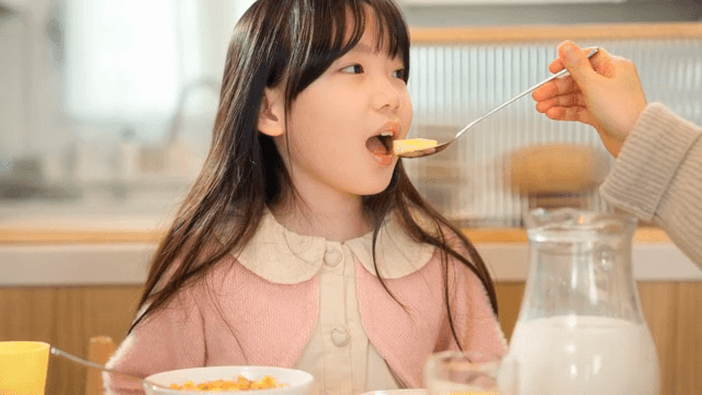 Child enjoying breakfast at home