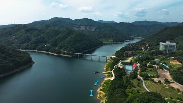 Serene Waterway Between the Mountains and the Village