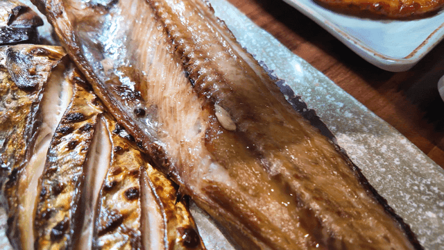 Lemon juice drizzled over grilled fish on plate