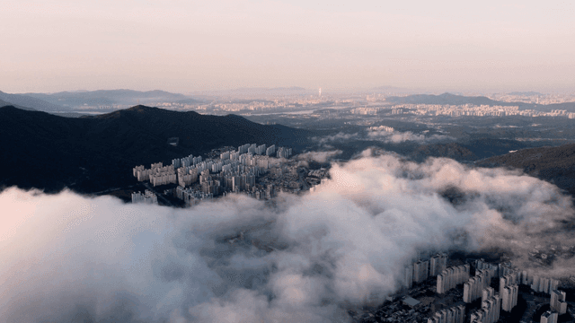 Cityscape with clouds and mountains