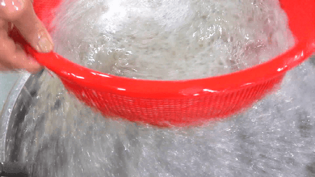 Washing ice fish in red basket