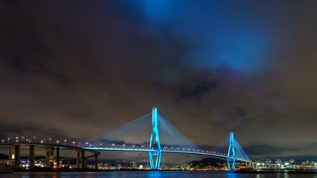 Colorful illuminated Busanhangdaegyo Bridge at night with cityscape