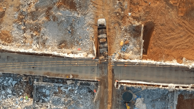 Construction site with trucks and debris