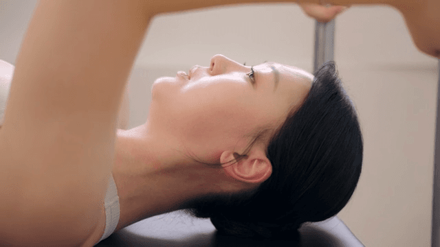 Woman lying on top of cadillac and breathing