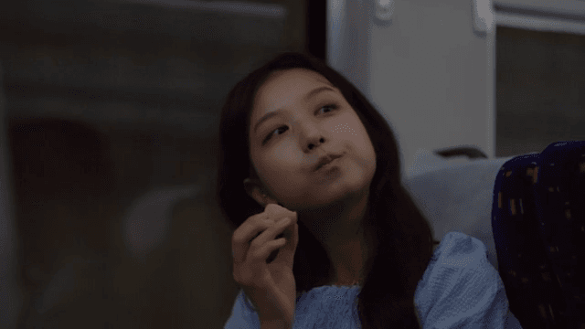 Woman eating eggs on a train
